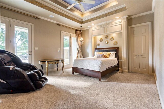 1317 Jack Nicklaus Cir, Salado, TX 76571 - carpeted bedroom with baseboards, a tray ceiling, access to outside, and crown molding