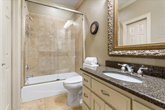1317 Jack Nicklaus Cir, Salado, TX 76571 - full bathroom featuring tile patterned floors, crown molding, toilet, vanity, and shower / bath combination with glass door