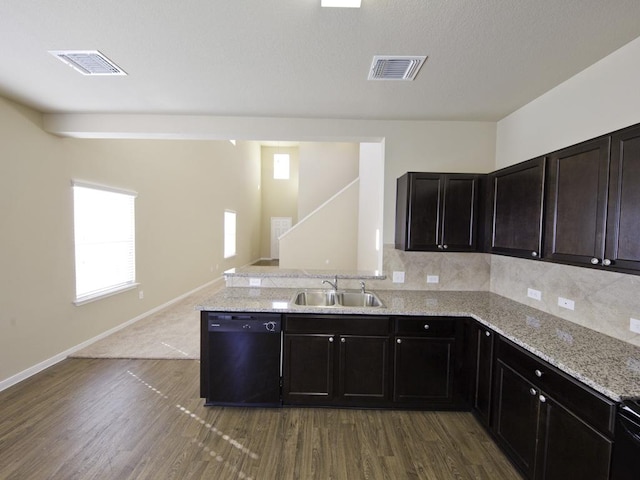 12110 Stoneridge Gap Ln, Manor, TX 78653 - kitchen with dishwasher, a sink, wood finished floors, and light stone countertops