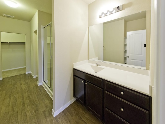 12110 Stoneridge Gap Ln, Manor, TX 78653 - full bathroom with wood finished floors, a stall shower, and a spacious closet