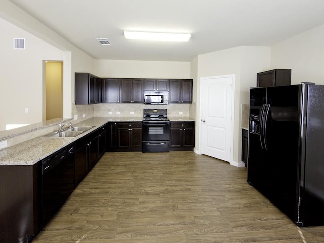 12110 Stoneridge Gap Ln, Manor, TX 78653 - kitchen featuring black appliances, dark brown cabinets, backsplash, wood finished floors, and a sink
