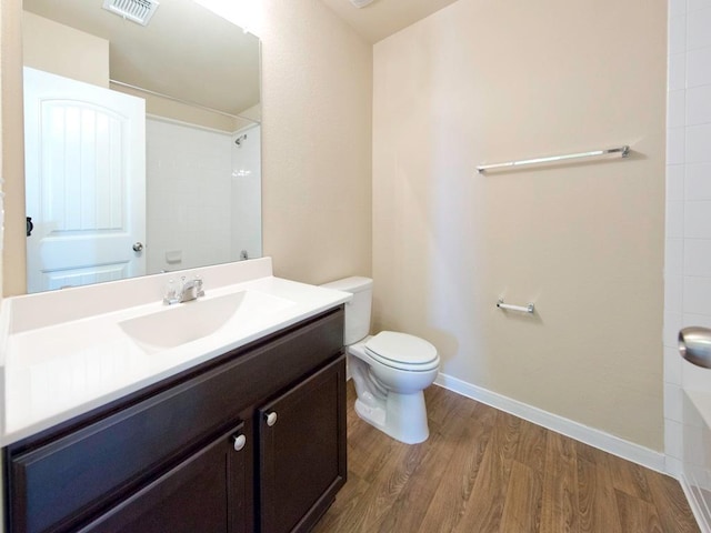 12110 Stoneridge Gap Ln, Manor, TX 78653 - bathroom featuring toilet, vanity, wood finished floors, a shower, and baseboards