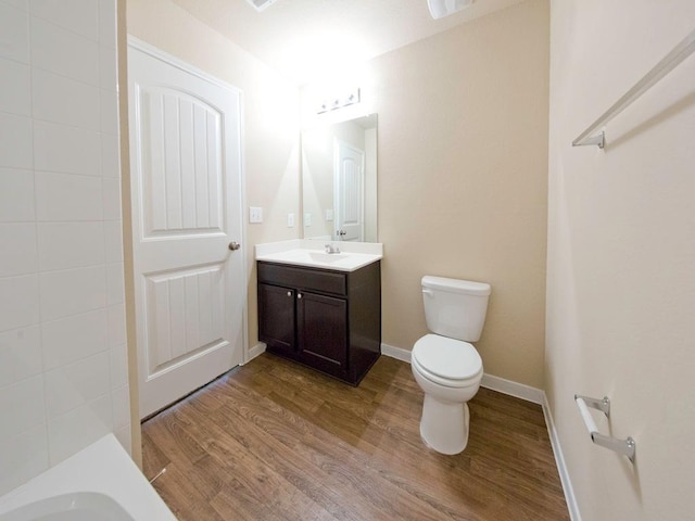 12110 Stoneridge Gap Ln, Manor, TX 78653 - bathroom with vanity, wood finished floors, toilet, and baseboards
