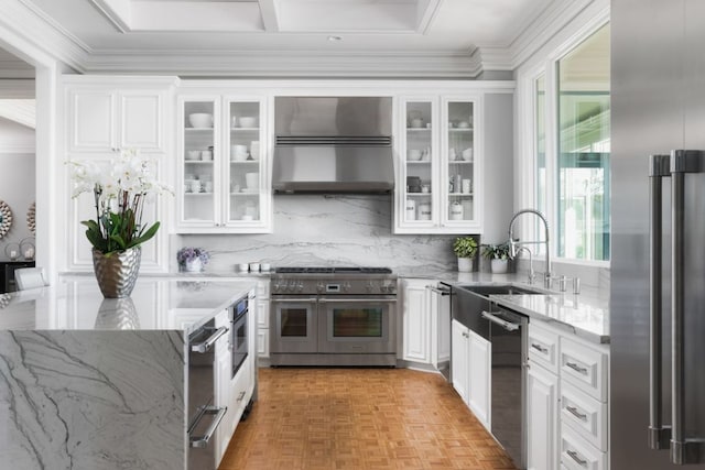 17 Cousteau Ln, Austin, TX 78746 - kitchen featuring high quality appliances, wall chimney exhaust hood, light stone counters, white cabinets, and crown molding