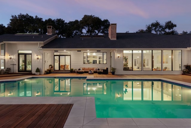 17 Cousteau Ln, Austin, TX 78746 - pool at dusk featuring an outdoor living space, an outdoor pool, a patio, and french doors