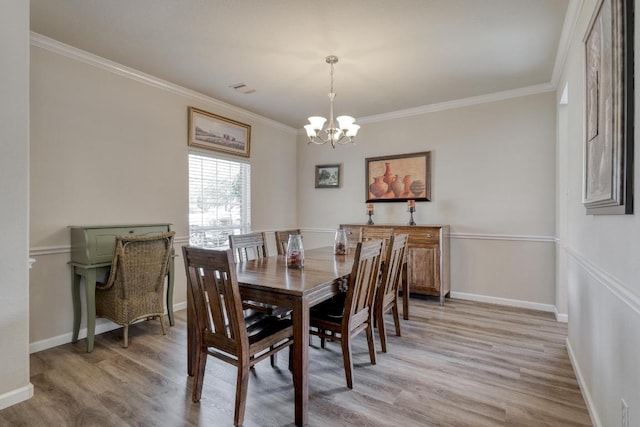 2209 Callaway Garden Ct, Pflugerville, TX 78660 - dining space featuring a chandelier, light wood-style flooring, ornamental molding, and baseboards