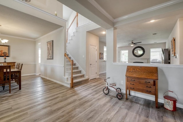 2209 Callaway Garden Ct, Pflugerville, TX 78660 - entrance foyer featuring stairway, light wood finished floors, crown molding, ceiling fan, and a chandelier