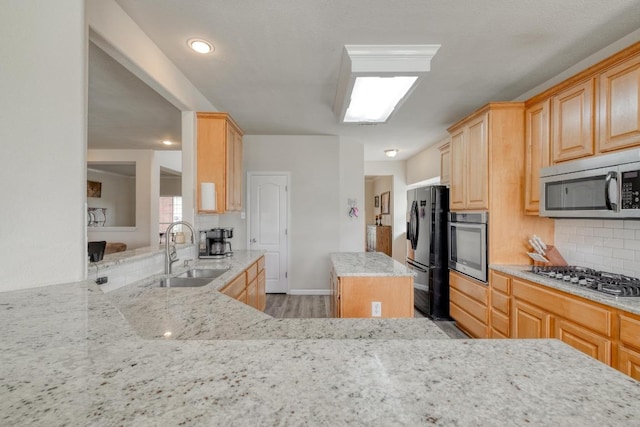 2209 Callaway Garden Ct, Pflugerville, TX 78660 - kitchen with a sink, appliances with stainless steel finishes, tasteful backsplash, light stone counters, and light brown cabinets