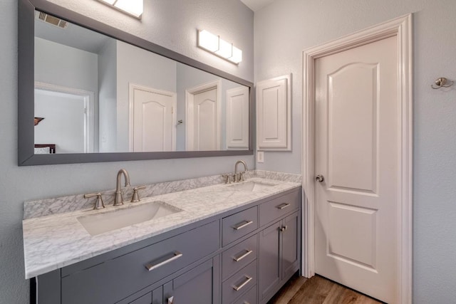 2209 Callaway Garden Ct, Pflugerville, TX 78660 - bathroom with double vanity and wood finished floors