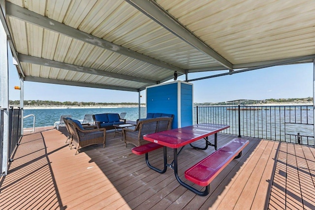 deck with a water view and an outdoor living space