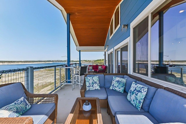 balcony with an outdoor living space and a water view
