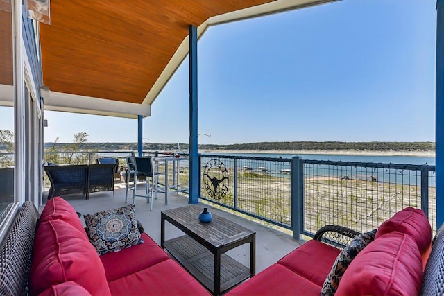 balcony with a water view and outdoor lounge area