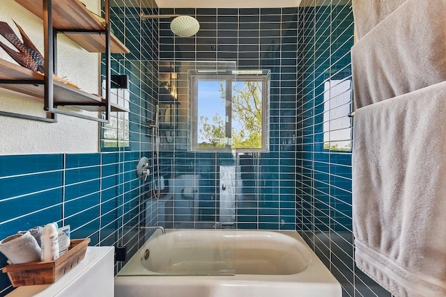 full bath featuring toilet, bathtub / shower combination, and tile walls