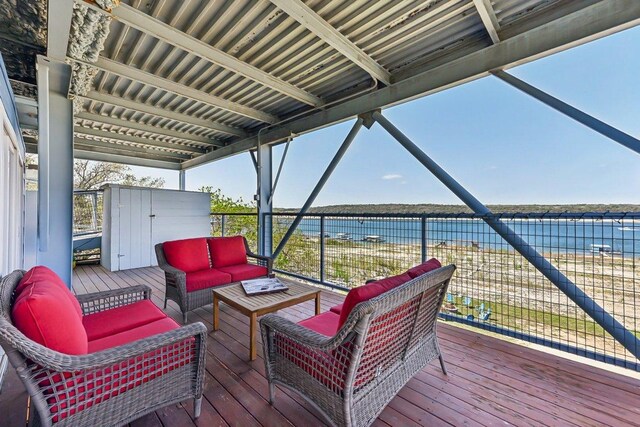 wooden deck with outdoor lounge area and a water view