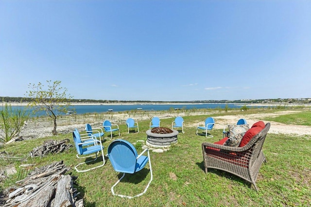view of yard featuring an outdoor fire pit and a water view