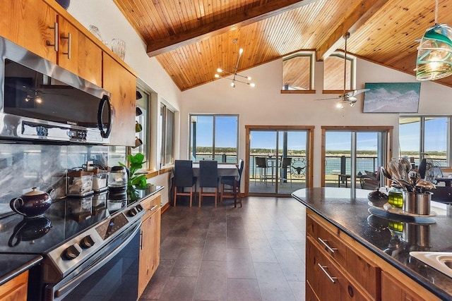 kitchen featuring plenty of natural light, brown cabinetry, beam ceiling, and stainless steel appliances