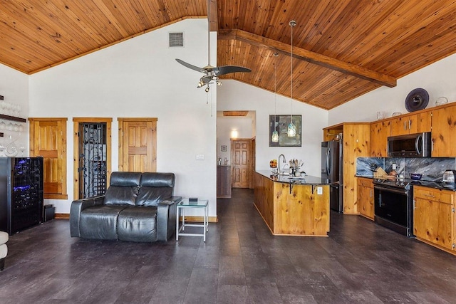 kitchen featuring freestanding refrigerator, visible vents, stainless steel microwave, dark countertops, and electric range