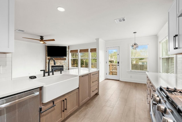 1290 Sweet Gum Dr, Kyle, TX 78640 - kitchen featuring stainless steel appliances, a sink, light countertops, decorative backsplash, and ceiling fan