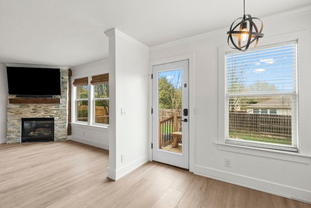 1290 Sweet Gum Dr, Kyle, TX 78640 - entryway with ornamental molding, light wood-style flooring, baseboards, and a fireplace
