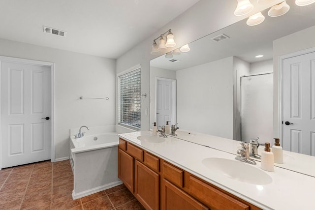 1290 Sweet Gum Dr, Kyle, TX 78640 - full bathroom featuring a bath, double vanity, a shower stall, tile patterned flooring, and baseboards