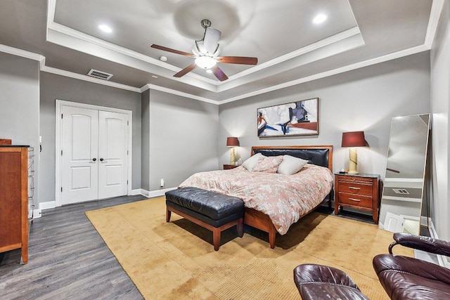 22000 Briarcliff Dr, Spicewood, TX 78669 - bedroom with a raised ceiling, crown molding, wood finished floors, recessed lighting, and a closet