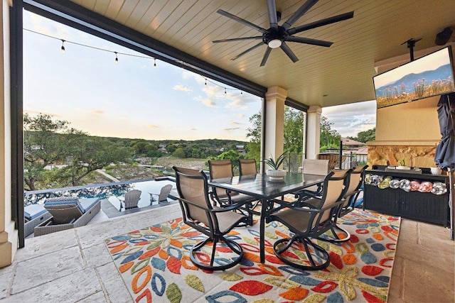 22000 Briarcliff Dr, Spicewood, TX 78669 - patio terrace at dusk with outdoor dining area and a ceiling fan