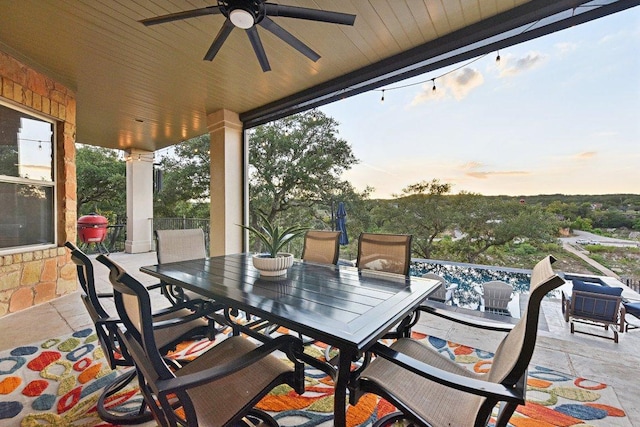 22000 Briarcliff Dr, Spicewood, TX 78669 - patio terrace at dusk with outdoor dining space, ceiling fan, and a patio area