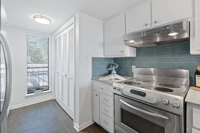 1101 Hollow Creek Dr Unit 2203, Austin, TX 78704 - kitchen featuring appliances with stainless steel finishes, range hood, baseboards, decorative backsplash, and white cabinetry