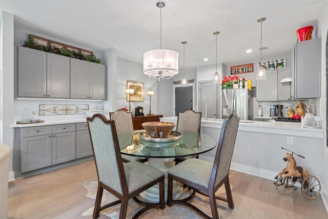 908 Nueces St Unit 36, Austin, TX 78701 - dining room featuring a chandelier, light wood-style floors, and recessed lighting