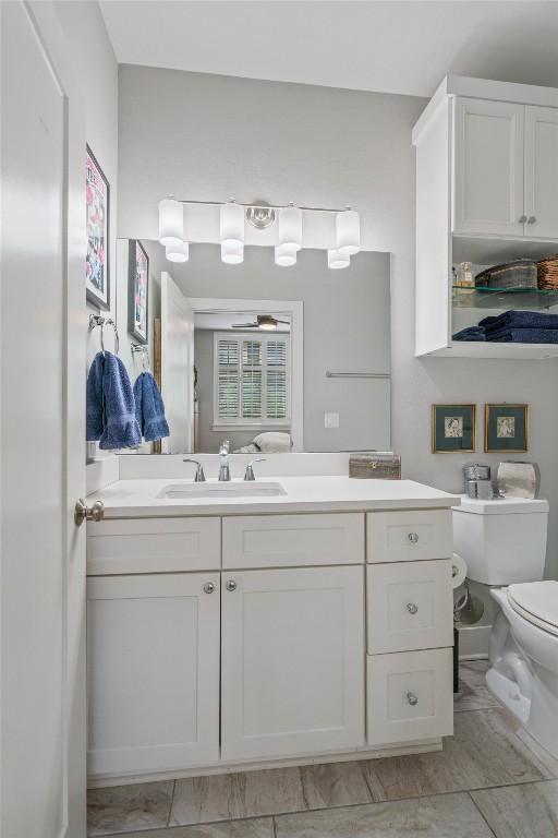 908 Nueces St Unit 36, Austin, TX 78701 - bathroom with vanity, toilet, and a ceiling fan
