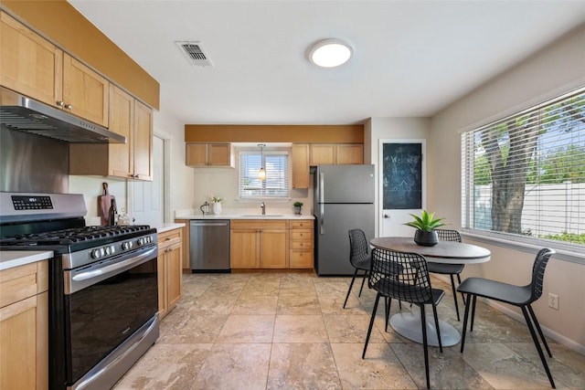 8313 Renton Dr, Austin, TX 78757 - kitchen featuring light countertops, appliances with stainless steel finishes, under cabinet range hood, and visible vents