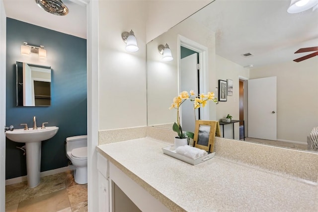 8313 Renton Dr, Austin, TX 78757 - bathroom with visible vents, a sink, toilet, baseboards, and a ceiling fan