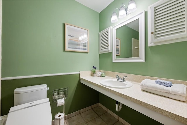 8313 Renton Dr, Austin, TX 78757 - bathroom with toilet, tile patterned floors, and a sink