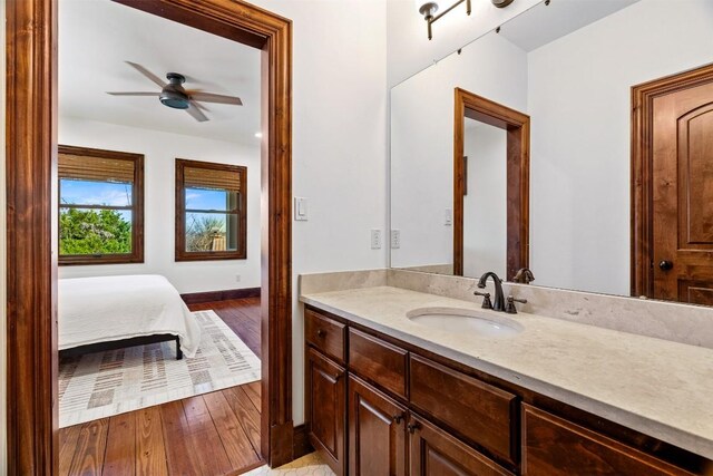 11 Hightrail Way, Austin, TX 78738 - bathroom with vanity, a ceiling fan, and wood finished floors