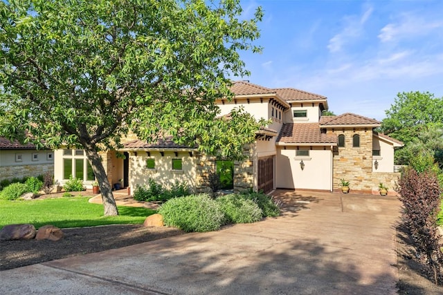 11 Hightrail Way, Austin, TX 78738 - view of front facade featuring stone siding, a tiled roof, stucco siding, and concrete driveway