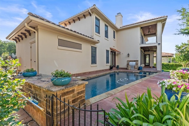 11 Hightrail Way, Austin, TX 78738 - rear view of house with a chimney, an outdoor pool, stucco siding, a balcony, and a patio
