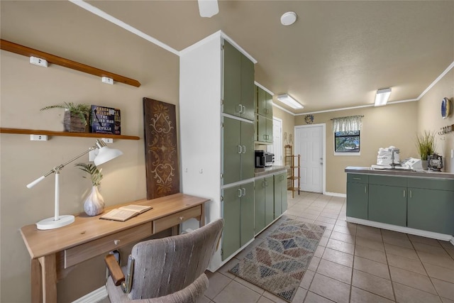 707 Golden Beach Dr, Buchanan Dam, TX 78609 - kitchen featuring green cabinetry, a desk, light tile patterned flooring, and crown molding