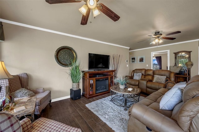 707 Golden Beach Dr, Buchanan Dam, TX 78609 - living room featuring a ceiling fan, baseboards, dark wood-style flooring, ornamental molding, and a glass covered fireplace