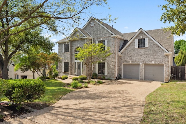 10406 Charette Cv, Austin, TX 78759 - view of front of home featuring driveway, an attached garage, brick siding, and roof with shingles