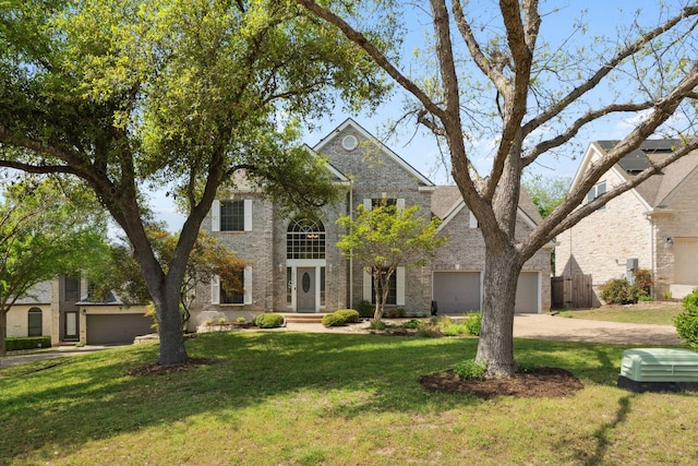 10406 Charette Cv, Austin, TX 78759 - colonial home featuring a front yard, driveway, and brick siding