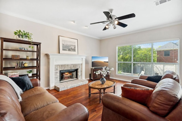 10406 Charette Cv, Austin, TX 78759 - living area with ceiling fan, wood finished floors, crown molding, a fireplace, and baseboards