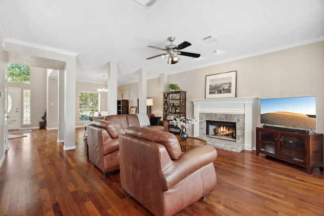 10406 Charette Cv, Austin, TX 78759 - living room with wood finished floors, ornamental molding, a fireplace, ceiling fan, and a chandelier