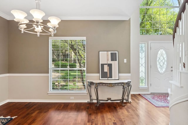10406 Charette Cv, Austin, TX 78759 - entryway with a chandelier, wood finished floors, baseboards, and crown molding