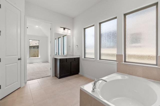 1800 Sauterne Dr, Leander, TX 78641 - full bathroom featuring a garden tub, vanity, plenty of natural light, and tile patterned flooring