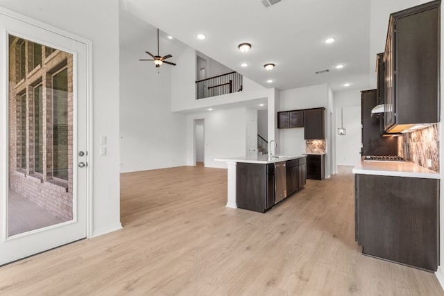 1800 Sauterne Dr, Leander, TX 78641 - kitchen featuring open floor plan, ceiling fan, light wood-type flooring, dark brown cabinetry, and recessed lighting