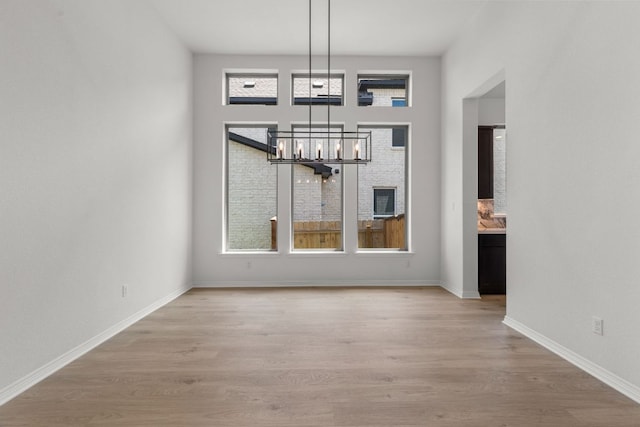 1800 Sauterne Dr, Leander, TX 78641 - unfurnished dining area with a chandelier and light wood-style floors
