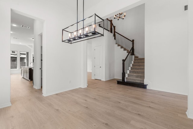 1800 Sauterne Dr, Leander, TX 78641 - unfurnished dining area featuring a chandelier, light wood finished floors, stairway, and recessed lighting