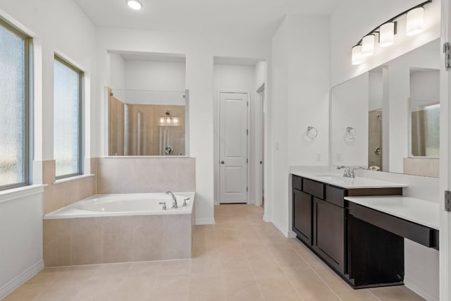1800 Sauterne Dr, Leander, TX 78641 - bathroom featuring a garden tub, vanity, tile patterned floors, and a tile shower