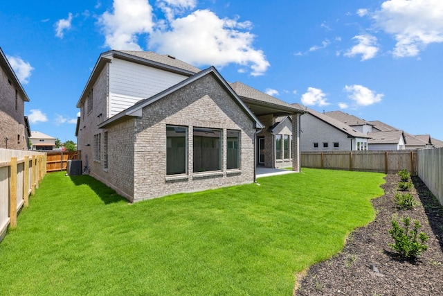 1800 Sauterne Dr, Leander, TX 78641 - rear view of house featuring a fenced backyard, brick siding, and a patio area