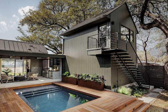 1202 Fieldcrest Dr, Austin, TX 78704 - back of house with stairs, a deck, an outdoor kitchen, and an outdoor living space